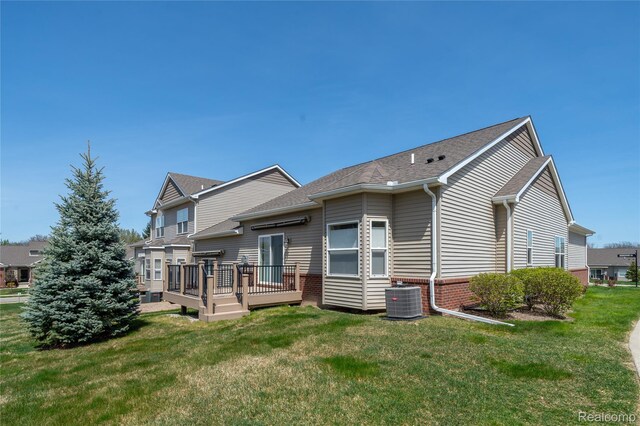3021 Berkshire Rd, Auburn Hills, MI 48326 - rear view of property featuring a wooden deck, a lawn, and central AC