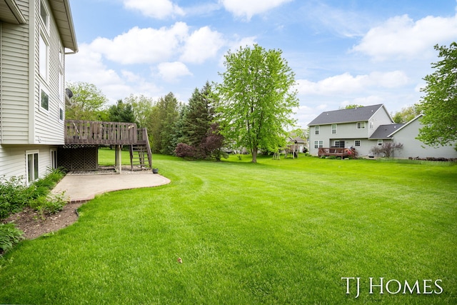 5348 Cristo Dr NE, Rockford, MI 49341 - view of green lawn with a patio area, a wooden deck, and stairway