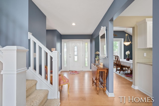 5348 Cristo Dr NE, Rockford, MI 49341 - foyer with stairs, light wood finished floors, baseboards, and recessed lighting