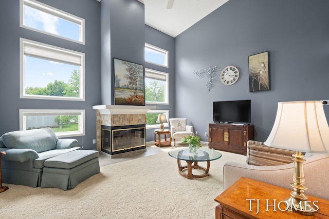 5348 Cristo Dr NE, Rockford, MI 49341 - living room with high vaulted ceiling, healthy amount of natural light, and a tile fireplace