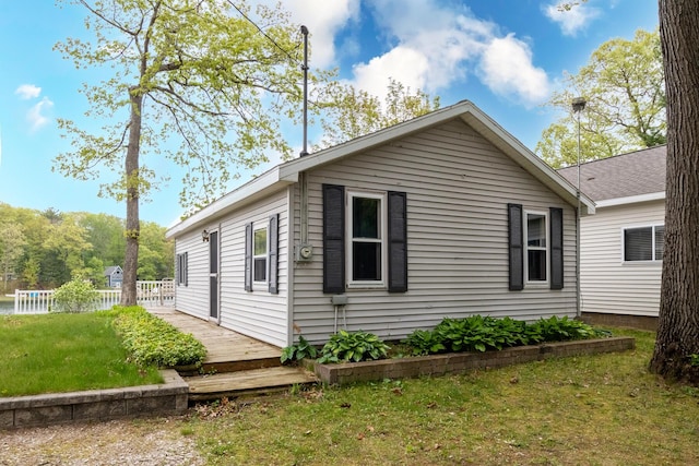 10138 S Lakeside Ridge Rd, Baldwin, MI 49304 - view of side of property with a lawn and a deck