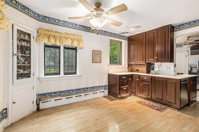 3261 Sherbourne Rd, Detroit, MI 48221 - kitchen with ceiling fan, wallpapered walls, light wood-type flooring, appliances with stainless steel finishes, and light countertops