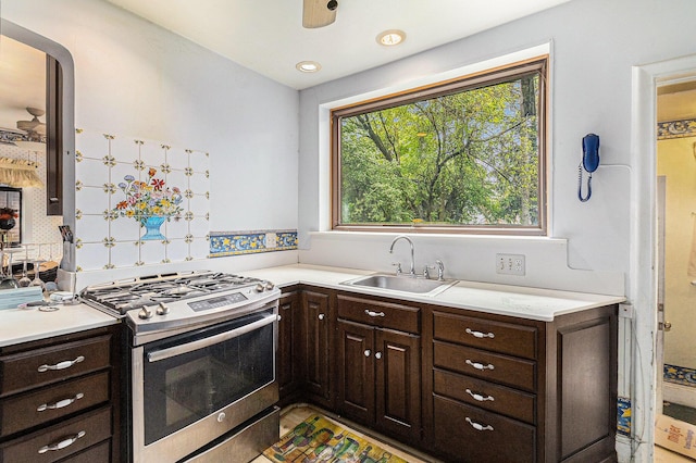 3261 Sherbourne Rd, Detroit, MI 48221 - kitchen featuring stainless steel gas range, a sink, light countertops, and dark brown cabinets