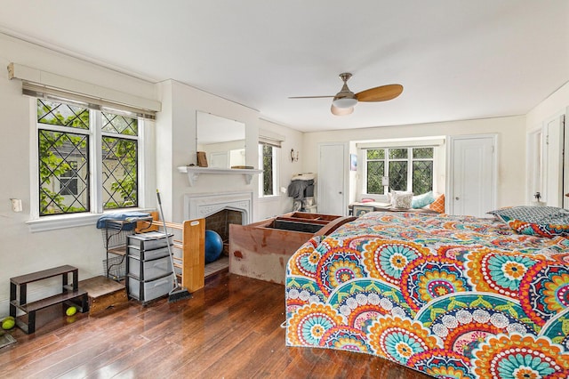 3261 Sherbourne Rd, Detroit, MI 48221 - bedroom with hardwood / wood-style flooring, multiple windows, a fireplace, and a ceiling fan