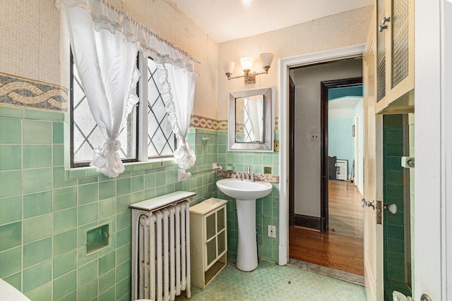 3261 Sherbourne Rd, Detroit, MI 48221 - bathroom featuring radiator, tile walls, a sink, and wainscoting