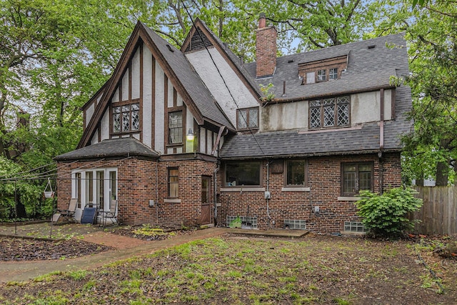 3261 Sherbourne Rd, Detroit, MI 48221 - back of property featuring a chimney, stucco siding, a shingled roof, and brick siding