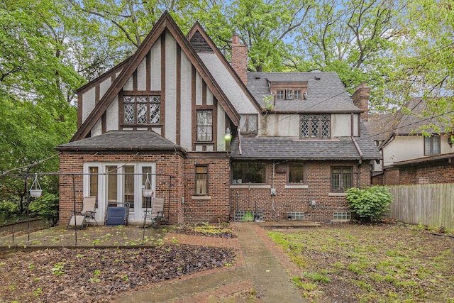 3261 Sherbourne Rd, Detroit, MI 48221 - rear view of house featuring a chimney, stucco siding, roof with shingles, and brick siding