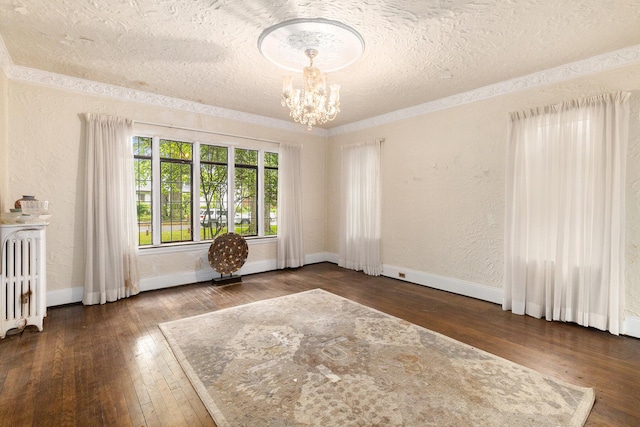 3261 Sherbourne Rd, Detroit, MI 48221 - spare room with radiator, hardwood / wood-style flooring, a chandelier, a textured ceiling, and a textured wall