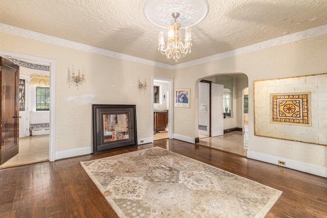3261 Sherbourne Rd, Detroit, MI 48221 - living room featuring dark wood-type flooring, a textured ceiling, arched walkways, baseboards, and a chandelier