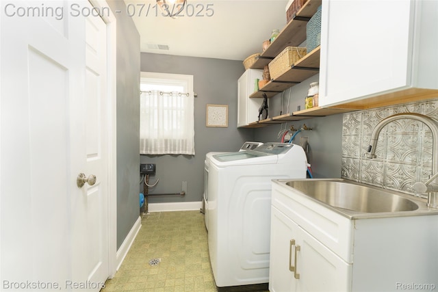 6245 Ray Rd, Swartz Creek, MI 48473 - washroom with cabinet space, washing machine and dryer, and light flooring