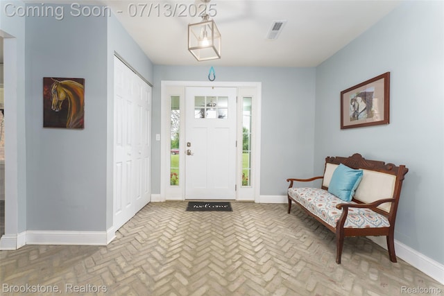 6245 Ray Rd, Swartz Creek, MI 48473 - foyer entrance featuring brick floors and baseboards