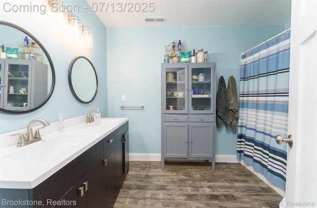 6245 Ray Rd, Swartz Creek, MI 48473 - full bath with wood finished floors and double vanity
