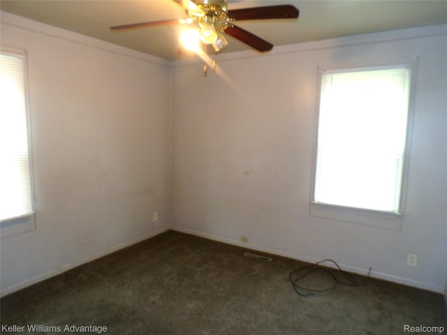 9162 Audubon Rd, Detroit, MI 48224 - unfurnished room with a ceiling fan, dark colored carpet, and baseboards
