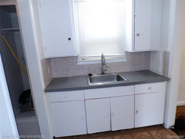 9162 Audubon Rd, Detroit, MI 48224 - kitchen with a sink, white cabinetry, and backsplash