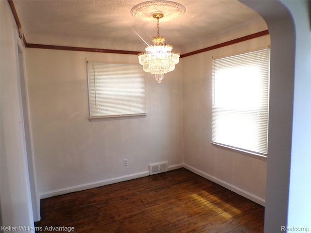 9162 Audubon Rd, Detroit, MI 48224 - unfurnished room with arched walkways, dark wood-style flooring, baseboards, a chandelier, and ornamental molding
