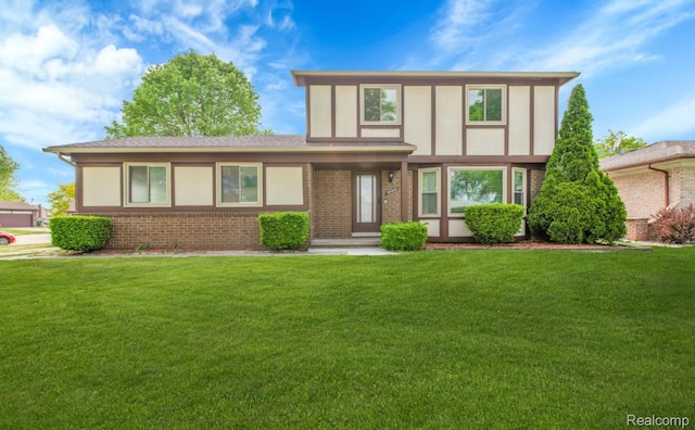 39321 Faith Dr, Sterling Heights, MI 48310 - tudor-style house featuring a front lawn and brick siding