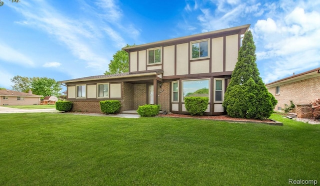 39321 Faith Dr, Sterling Heights, MI 48310 - english style home featuring a front yard, brick siding, and stucco siding