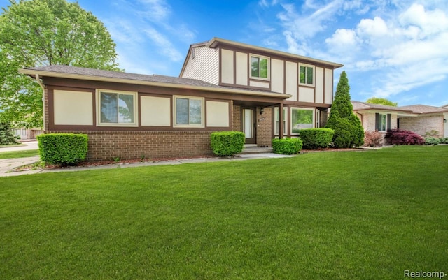 39321 Faith Dr, Sterling Heights, MI 48310 - tudor-style house featuring brick siding and a front yard