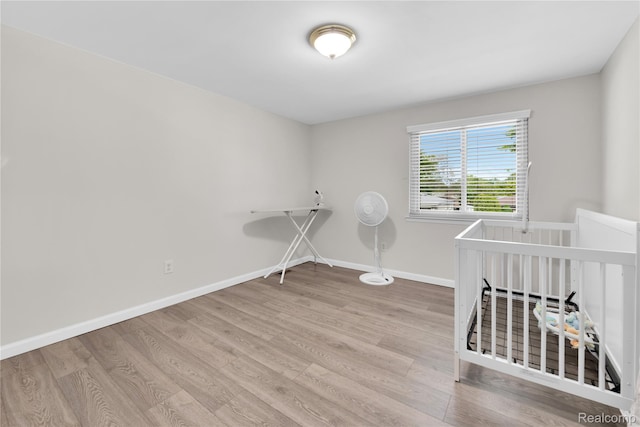 39321 Faith Dr, Sterling Heights, MI 48310 - unfurnished bedroom featuring wood finished floors and baseboards