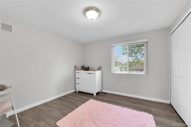 39321 Faith Dr, Sterling Heights, MI 48310 - bedroom with wood finished floors, baseboards, and a closet
