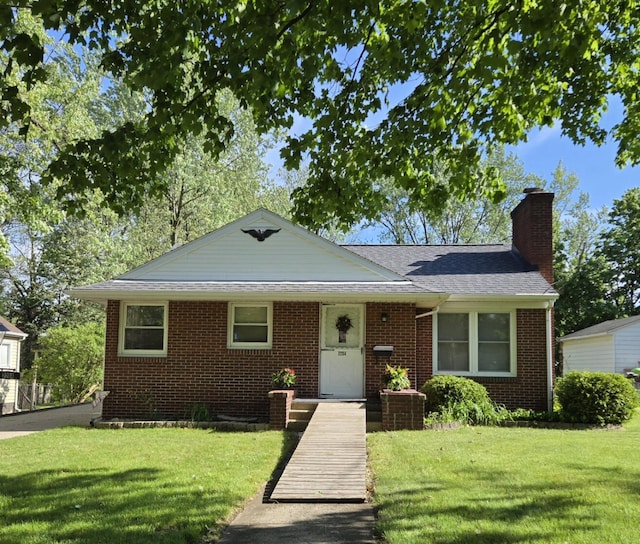 2204 Lakeway Ave, Kalamazoo, MI 49001 - bungalow-style home with a front yard, a chimney, brick siding, and a shingled roof