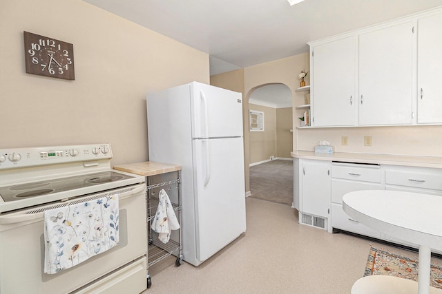 2204 Lakeway Ave, Kalamazoo, MI 49001 - kitchen with white appliances, white cabinetry, light countertops, and light colored carpet