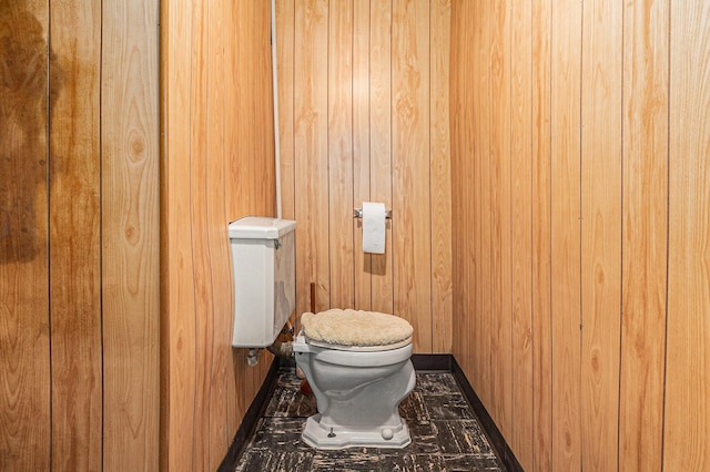 2204 Lakeway Ave, Kalamazoo, MI 49001 - bathroom featuring toilet, baseboards, and wooden walls
