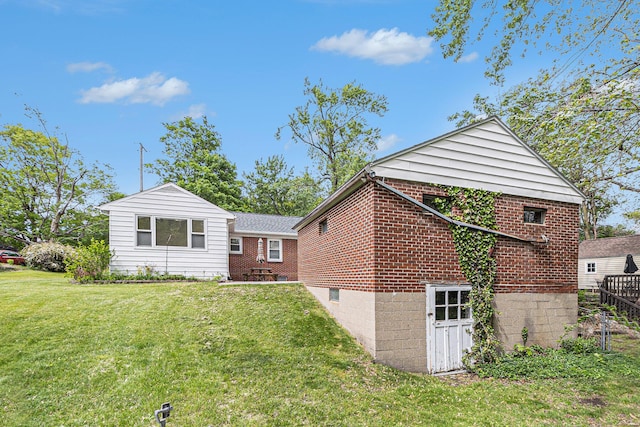 2204 Lakeway Ave, Kalamazoo, MI 49001 - back of property featuring a lawn and brick siding