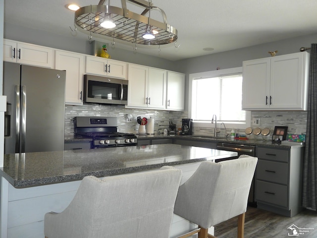 12067 Lewis Ave, Temperance, MI 48182 - kitchen with appliances with stainless steel finishes, a sink, tasteful backsplash, and white cabinetry