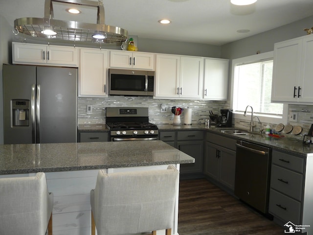 12067 Lewis Ave, Temperance, MI 48182 - kitchen featuring stainless steel appliances, a sink, dark stone countertops, tasteful backsplash, and recessed lighting