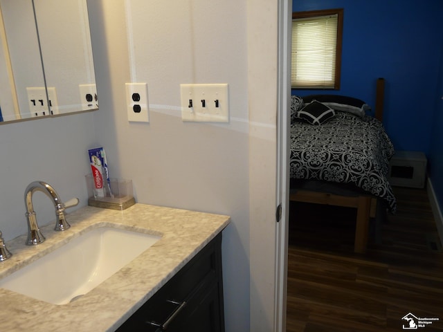 12067 Lewis Ave, Temperance, MI 48182 - bathroom with wood finished floors, vanity, and ensuite bath
