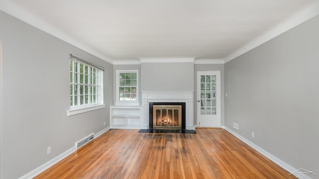1355 Hemmeter Rd, Saginaw, MI 48638 - unfurnished living room featuring wood-type flooring, a fireplace with flush hearth, and baseboards