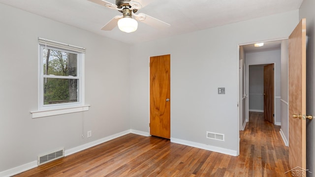 1355 Hemmeter Rd, Saginaw, MI 48638 - unfurnished bedroom with wood finished floors, baseboards, and a ceiling fan