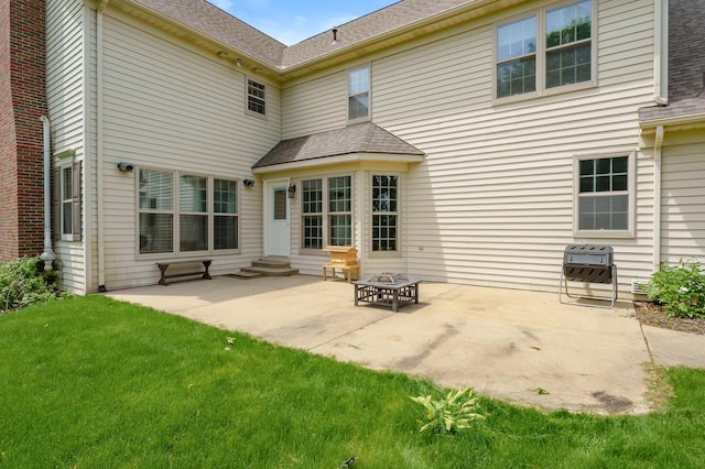 3638 Bellflower Dr, Portage, MI 49024 - back of house featuring entry steps, a patio area, heating unit, a lawn, and roof with shingles