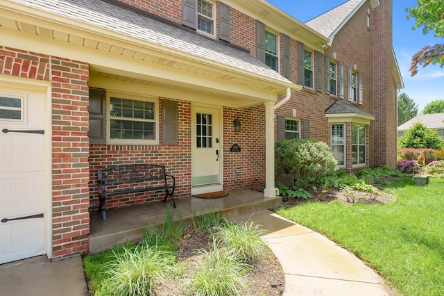 3638 Bellflower Dr, Portage, MI 49024 - property entrance featuring brick siding, roof with shingles, and a lawn