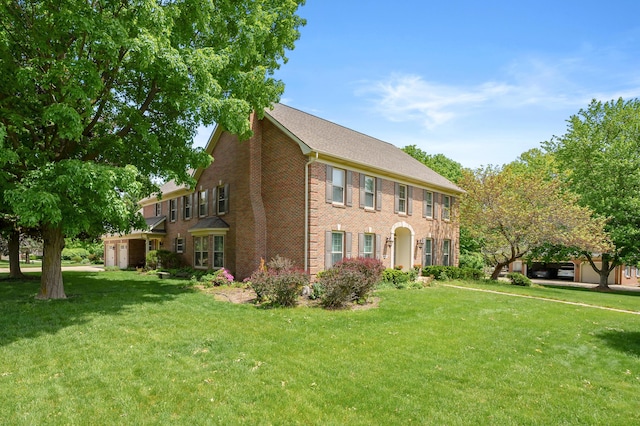 3638 Bellflower Dr, Portage, MI 49024 - view of front facade with a front lawn, brick siding, and a carport