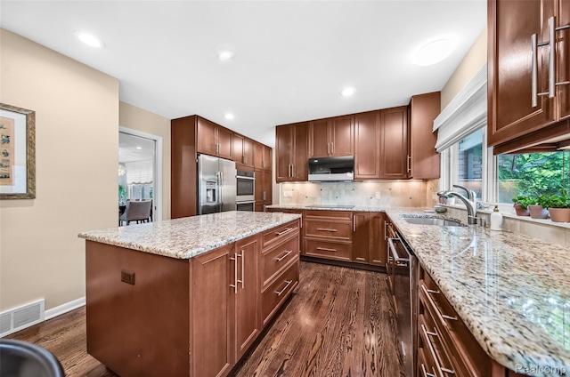 5259 Echo Rd, Bloomfield Hills, MI 48302 - kitchen featuring appliances with stainless steel finishes, a sink, dark wood-type flooring, a center island, and light stone counters