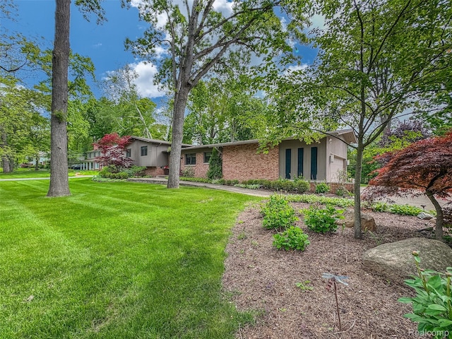 5259 Echo Rd, Bloomfield Hills, MI 48302 - view of front of property with a front yard, brick siding, and a garage