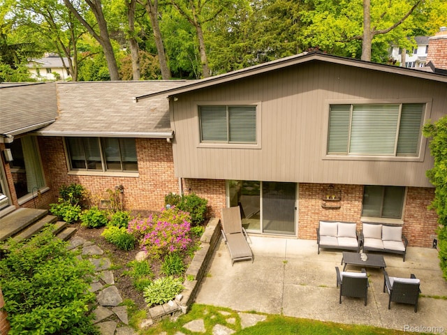 5259 Echo Rd, Bloomfield Hills, MI 48302 - view of front facade featuring an outdoor living space, brick siding, a patio, and roof with shingles