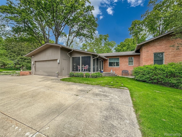 5259 Echo Rd, Bloomfield Hills, MI 48302 - view of front of home featuring a sunroom, a front lawn, a garage, driveway, and brick siding