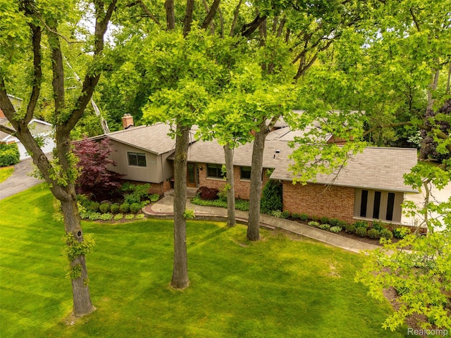 5259 Echo Rd, Bloomfield Hills, MI 48302 - view of front of property with brick siding, a front yard, and roof with shingles
