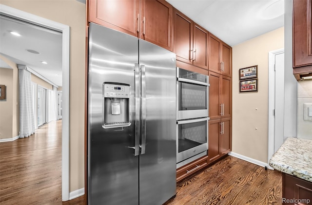 5259 Echo Rd, Bloomfield Hills, MI 48302 - kitchen with stainless steel appliances, dark wood-style floors, baseboards, brown cabinetry, and recessed lighting