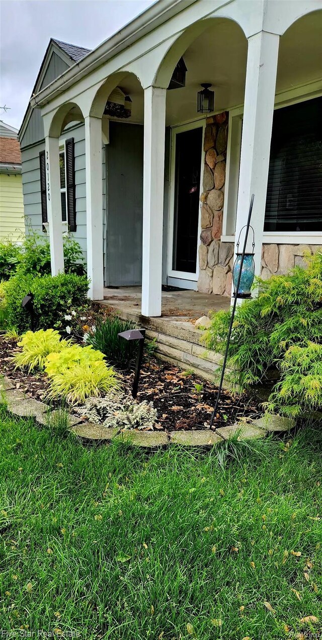20120 Rensellor St, Livonia, MI 48152 - property entrance featuring stone siding and a porch