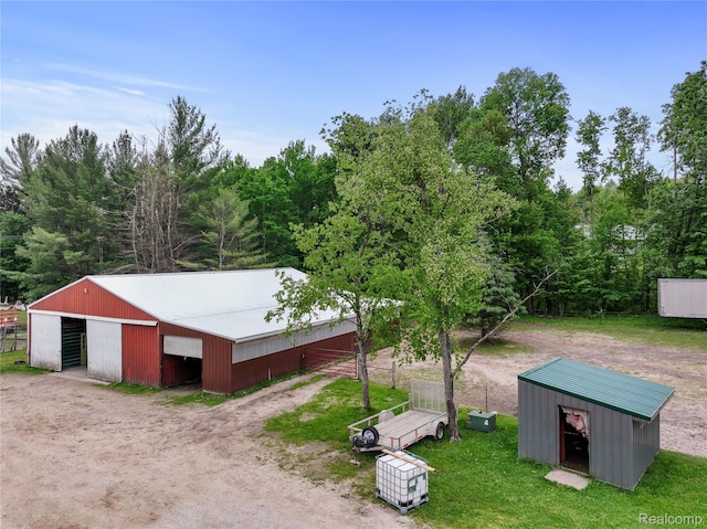 8875 N Lakola Rd, Tustin, MI 49688 - view of pole building featuring driveway