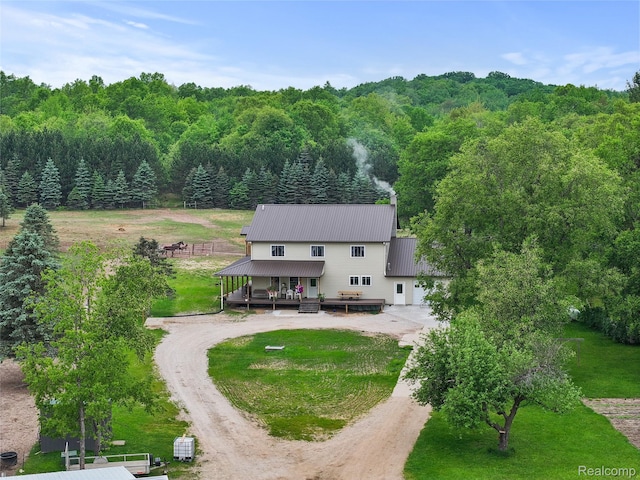 8875 N Lakola Rd, Tustin, MI 49688 - back of house with curved driveway, a forest view, and metal roof