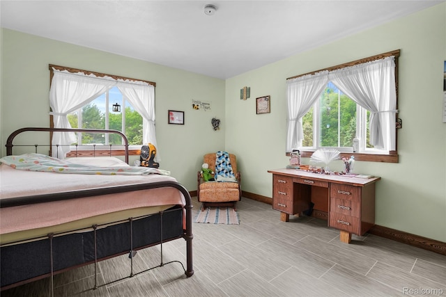 8875 N Lakola Rd, Tustin, MI 49688 - bedroom with multiple windows and baseboards