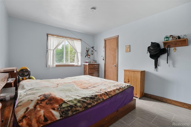 8875 N Lakola Rd, Tustin, MI 49688 - bedroom featuring baseboards