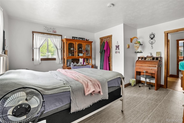 8875 N Lakola Rd, Tustin, MI 49688 - bedroom with baseboards and a closet