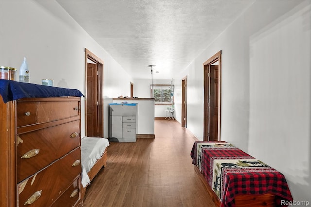 8875 N Lakola Rd, Tustin, MI 49688 - bedroom featuring wood finished floors and a textured ceiling