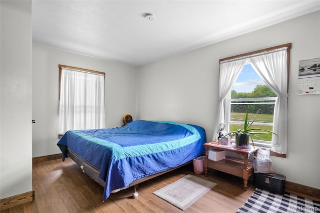 8875 N Lakola Rd, Tustin, MI 49688 - bedroom with baseboards and wood finished floors